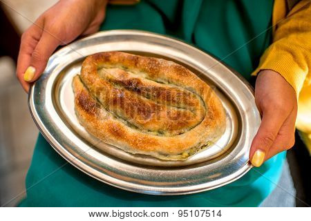 Holding Burek on the metal plate