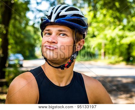 Professional cyclist smiling with helmet on the head for safety