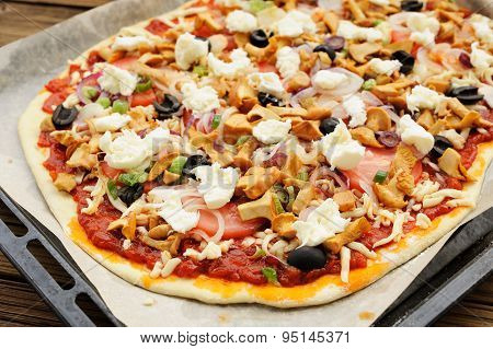 Raw Al Funghi Pizza With Chanterelle Mushrooms And Olives On Baking Paper