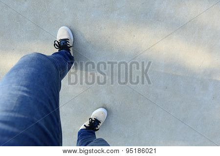 closeup of skateboarder legs stand on ramp