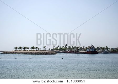 Boat dredger creating land coastline in Souly Bay Salalah Oman 2