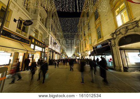 VIENNA AUSTRIA - 2ND DECEMBER 2016: A view along Kohlmarkt in Vienna at Christmas. Lots of people decorations and the outside of shops can be seen.