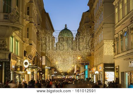 VIENNA AUSTRIA - 2ND DECEMBER 2016: A view along Kohlmarkt in Vienna at Christmas. Lots of people decorations and the outside of shops can be seen.