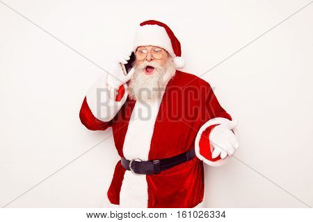 Old Busy Santa Claus In Red Costume Talking On Smartphone