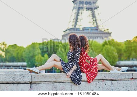 Beautiful Twin Sisters In Front Of The Eiffel Tower In Paris