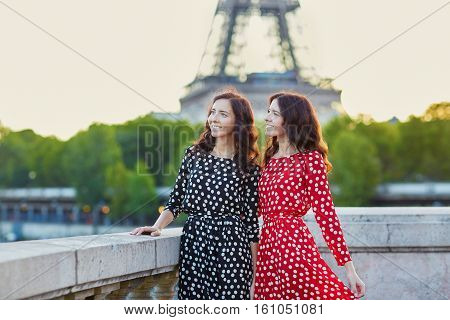 Beautiful Twin Sisters In Front Of The Eiffel Tower In Paris