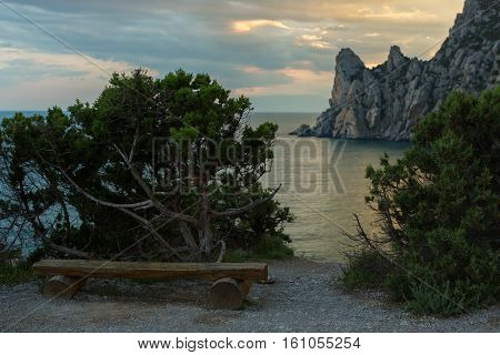 Wooden bench on a background of Blue bay and mount Karaul-Oba.