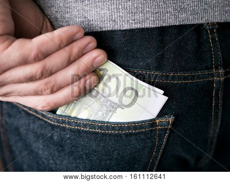 Hand Put Euro In Jeans Pocket