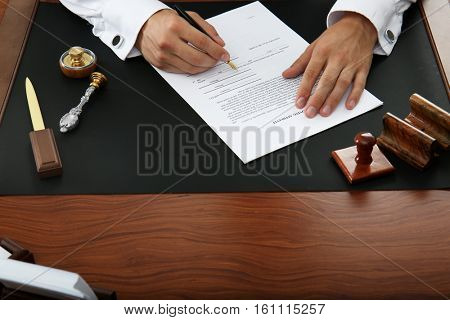 Notary public signing document in office