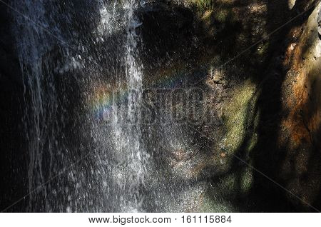 Rainbow at the waterfall Millomeris in the mountains in Cyprus