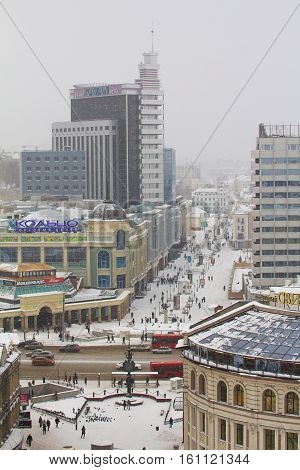 KAZAN, RUSSIA - DECEMBER 11, 2016: center Peterbugskaya street, Grand hotel, crowded street, winter snow cloudy day, telephoto