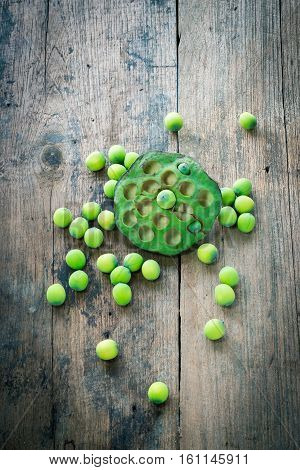 Lotus seeds and calyx on wooden background