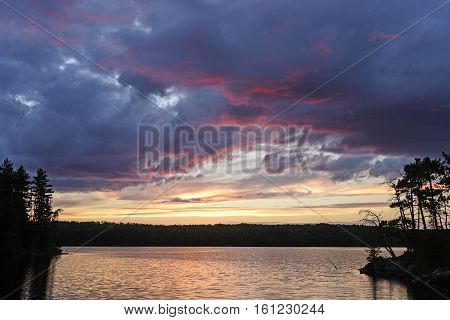 Purple Clouds and Silhouettes ar Sunset on Agnes Lake in Quetico Provincial Park in Ontario