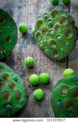 Lotus seeds and calyx on wooden background