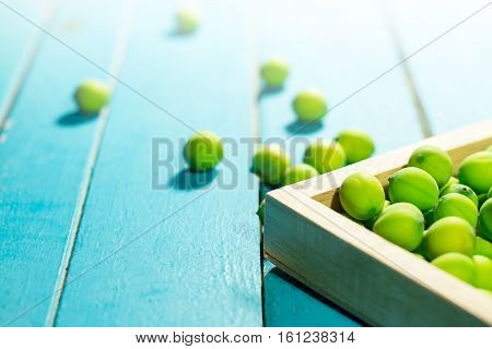 Lotus seeds in wooden frame on light blue wooden background