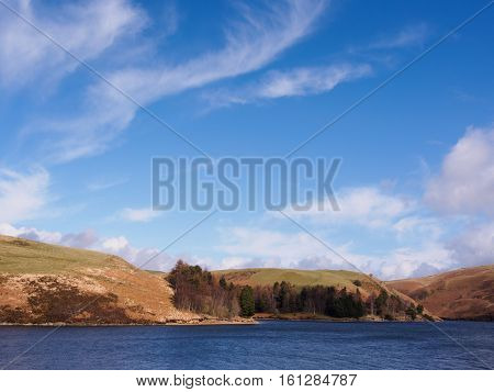 Llyn Clywedog is a man made reservoir formed by the construction of the Clywedog Dam. The lake has a surface area of 615 acres is 216 ft deep at its maximum depth and stretches a distance of six miles. It is located near Llanidloes Powys Wales. Photograph