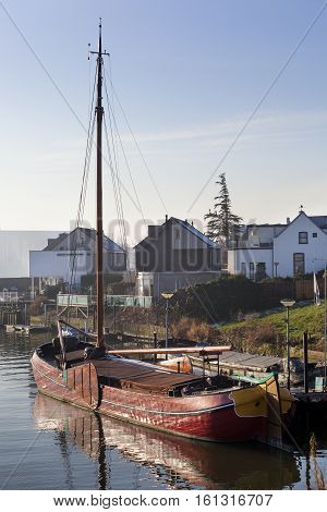 Historic wooden ship moored in village Lekkerkerk in the Netherlands