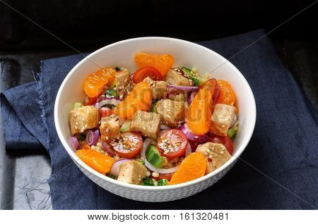 Healthy Salad Bowl With Cuscus, Tomatoes, Cucumber, Chicken, Tangerine And Sesame Seeds