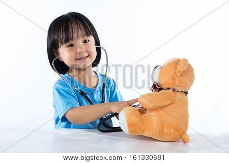 Happy Asian Chinese Little Doctor Girl Examine Teddy Bear