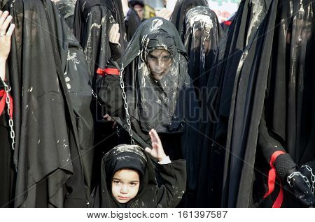 Istanbul Turkey - October 11 2016: Turkish Shia women takes part in an Ashura parade in Istanbul's district of Kucukcekmece. Turkish Shia Muslims mourning for Imam Hussain. Caferis take part in a mourning procession marking the day of Ashura in Istanbul's