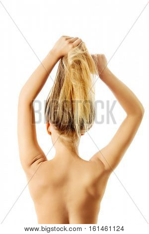 Photo of combing woman with long blond hair