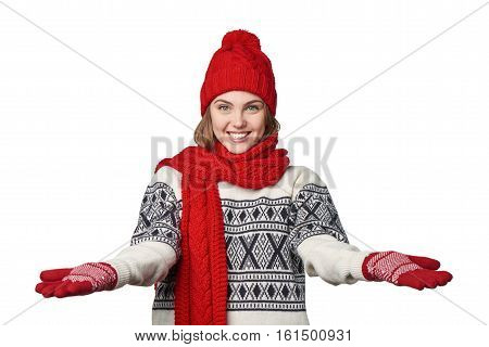 Happy hospitable young woman in warm winter clothing with opened arms salutating