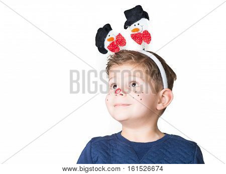 lovely and adorable boy kid child with Christmas paint on his face and snowman on his head