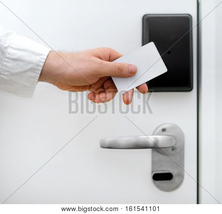 Man using contactless key in the hotel.