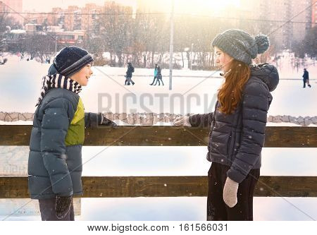 Moscow, Russia, December 9, 2016: Unidentified kids in warm winter clothes boy and girl on open air ice rink close up photo faving fun in park on weekend in Moscow, December 9, 2016.