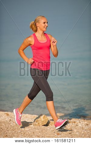 Jogging In Th Beach - Woman Runns Near Sea On Early Summer Morning