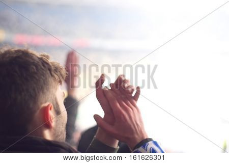 fans in the stadium supporting the team in the winter