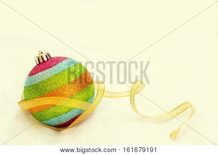 Rainbow Christmas Ball With Ribbon With Free Copy Space Background.