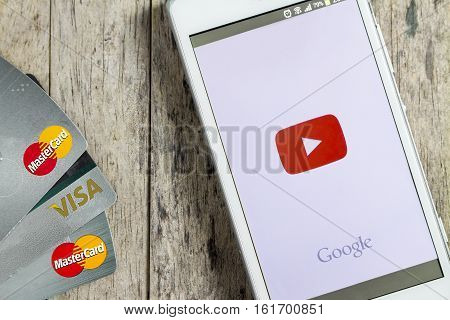 BUNGKAN THAILAND - NOVEMBER 10 2015: smart phone with Facebook login on screen and credit card on wood background