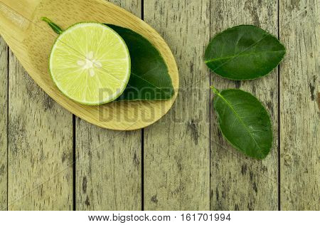 lime slice and leaf on wood padle