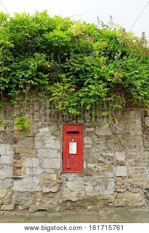 ELY, ENGLAND - JUNE 28, 2016: Post Box in Ely Cambridgeshire. Fine George sixth post box in the wall near the Cathedral of Ely.
