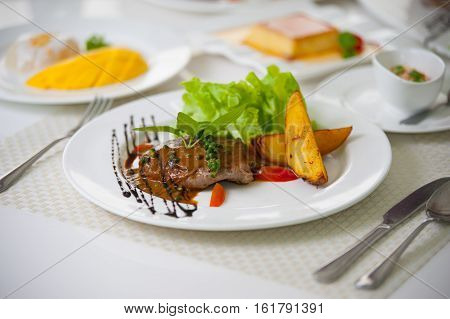 grill steak with Potatoes on white plate