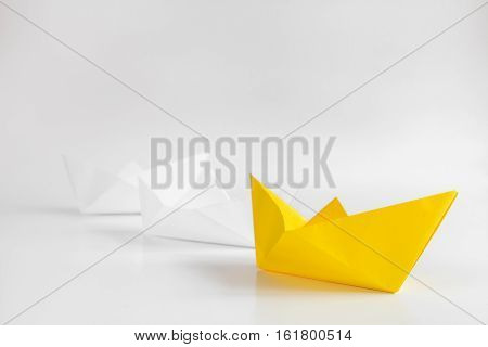 choice concept paper boats on white background close up