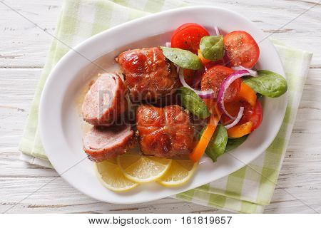 Roasted Rabbit Fillet With A Salad Of Fresh Vegetables Close-up. Horizontal Top View