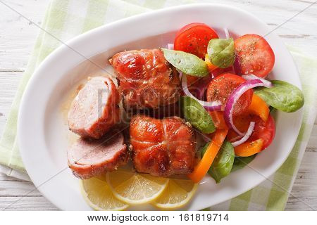 Baked Rabbit Fillet And Salad Of Tomatoes, Peppers, Spinach And Onion Close-up. Horizontal Top View