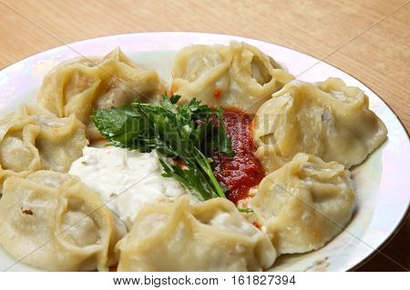 Manta on a plate with two kinds of sauce.