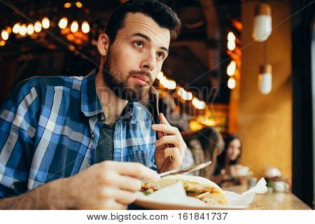 Handsome Young Man Having Lunch In Elegant Restaurant Alone