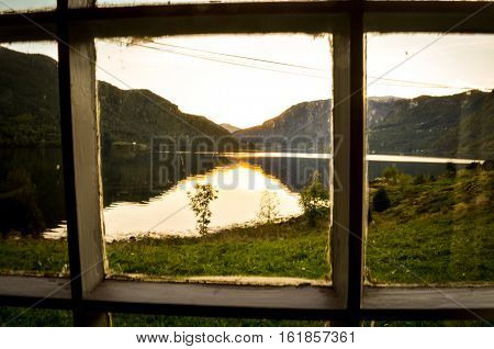idyllic view through window in norwegian fjord