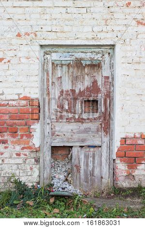 Old wooden door in a brick wall walled