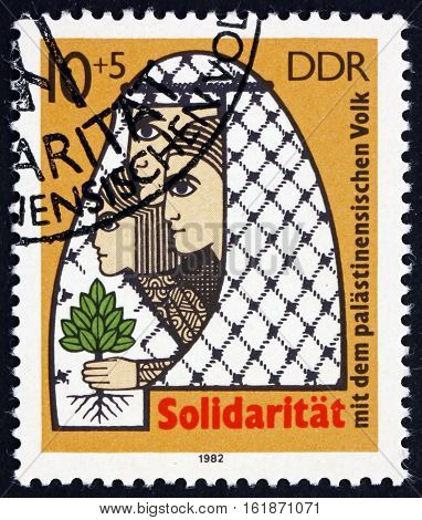 GERMANY - CIRCA 1982: a stamp printed in Germany shows Palestinian Family and Tree of Life Palestinian Solidarity circa 1982