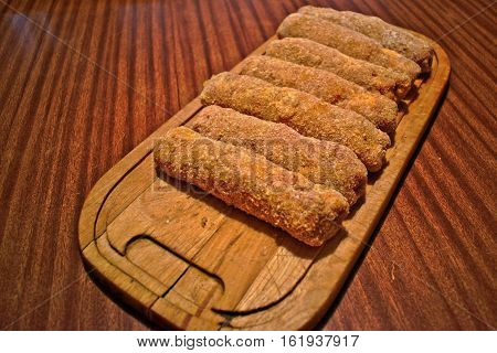 Stuffed Karadjordje schnitzels on a cutting board