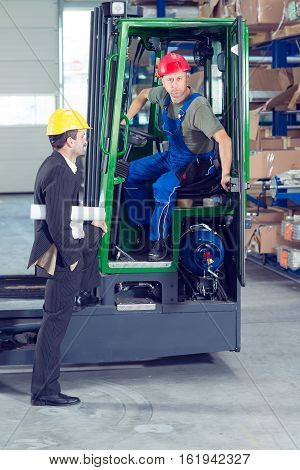 Boss And Worker In Lift Truck