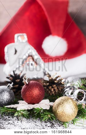 Christmas or New Year decoration with fir-tree branch cones balls and Santa hat. Winter holidays Christmas or New Year concept. Selective focus.