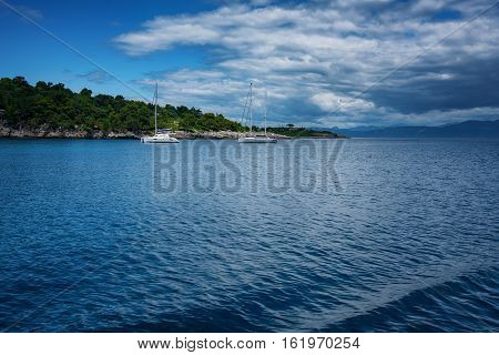 The Island of Paxos, Greece, 22 May, 2016: Early summer of the Island of Paxos - The Port of the Island of Paxos with buildings and boats around it.