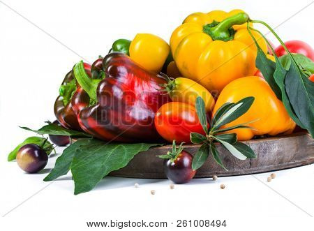 Assorted tomatoes and vegetables isolated on white background. Photo for your design