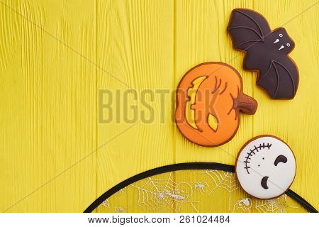 Assorted Hallowen Cookies On Yellow Background. Halloween Holiday Sugar Biscuits Including Pumpkin, 